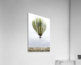 hot air balloon with Perrier lettering flies over the city of go Acrylic Print