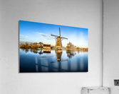 Windmill reflecting in water at sunset Acrylic Print