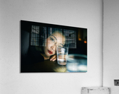 Young woman looking through a glass of water Acrylic Print