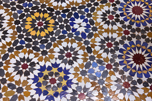 Ceramics students in Fez create stunning tile designs with vibrant colors and complex shapes showcasing their traditional craft skills and artistic talent in a historic school setting