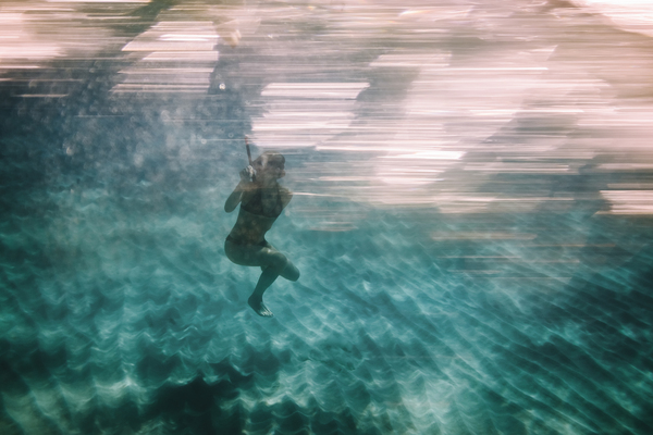 Woman diving underwater for snorkeling by simowave