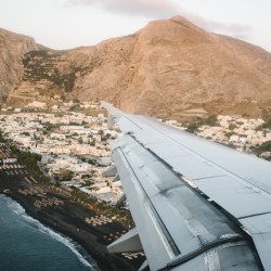 Airplane is landing in Santorini Island