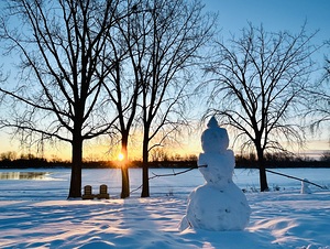 Sunrise over a snowman by Genevieve Gagnon