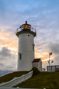 Sun Setting Behind Flashing Nobska Light Tower on Cape Cod in Massachusetts