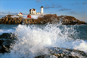 Waves Crashing Over Rocks by Cape Neddick Nubble Lighthouse During the Holidays in Maine