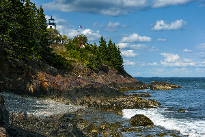 Owls Head Lighthouse Over Rocky Cliffs During Low Tide in Maine