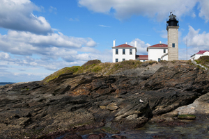 Beavertail Lighthouse Over Dangerous Rocky Shoreline in Rhode Island