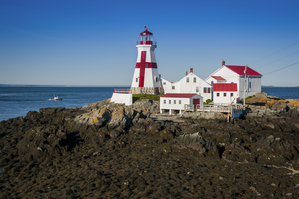 Head Harbor Lighthouse Guides Fishing Boat at Low Tide on Campobello Island in Canada