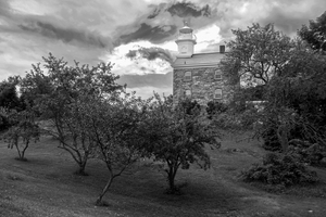 Great Captain Island Lighthouse on Hilltop Among Trees in Connecticut - B&W