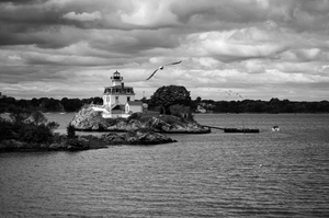 Sun Breaking Through Storm Clouds By Pomham Rocks Light in Rhode Island - B&W