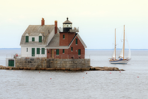 Sailboat Passes Rockland Breakwater Light on a Calm Day in Maine
