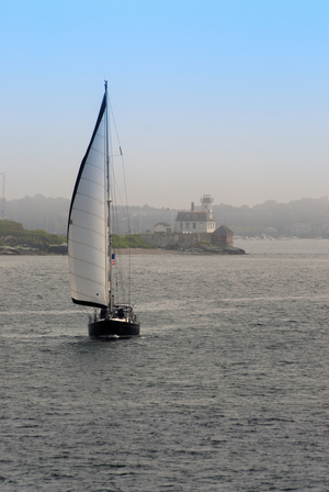 Sailboat Passes Rose Island Lighthouse as Fog Begins to Lift in Rhode Island