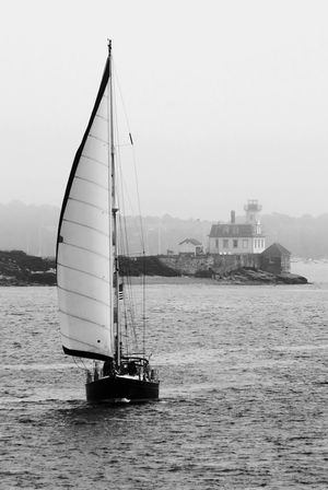 Sailboat Passes Rose Island Light in Newport Harbor Fog in Rhode Island - B&W