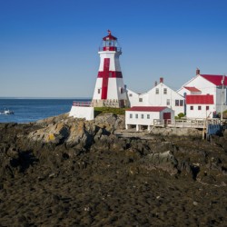 Head Harbor Lighthouse Guides Fishing Boat at Low Tide on Campobello Island in Canada