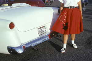 WOMAN IN RED POODLE SKIRT NEXT TO WHITE 1950s CAR 192873