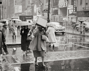 1950s WOMAN HOLDING BOX SUDDEN RAIN STORM PHILA PA 232631