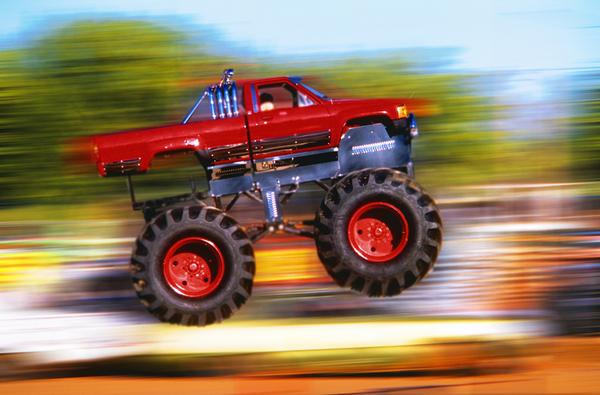 BIG WHEELED RED TRUCK JUMPING BLURRED BACKGROUND 184837 Print