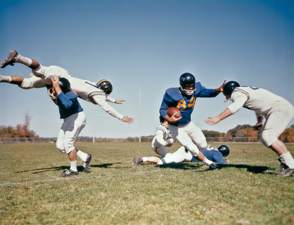 1964 FOOTBALL PLAYER WITH BALL FENDING OFF TACKLES 192594 by Panoramic Images