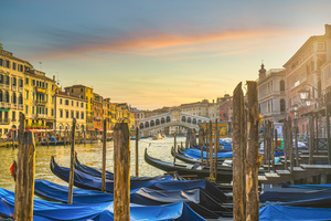 Gondolas in Grand Canal and Rialto bridge at sunrise. Venice