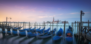 Venice lagoon San Giorgio church and gondolas at sunrise. Italy