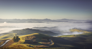 Volterra foggy landscape at sunrise. Italy