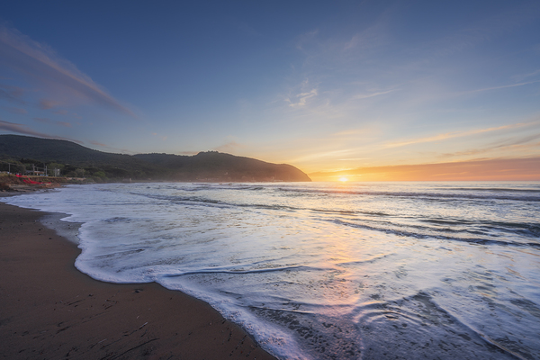 Waves on the Baratti beach at sunset. Tuscany Italy Print