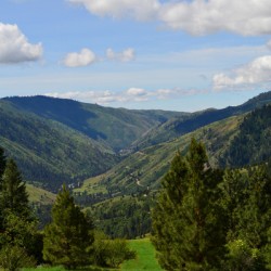 Banks Idaho rolling hills and dirt road under a beautiful cloudy sky