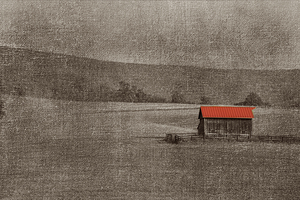 Red roof on barn in middle of field