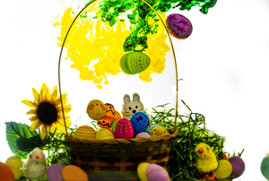 Easter basket with light yellow and green cloud hovering over the basket