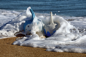 halloween pumpkins in wave on beach 0068