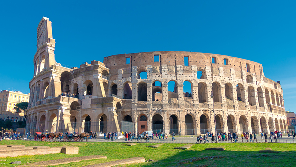 The Colosseum a famous landmark of ancient rome under a sunny sky. by IB Photography