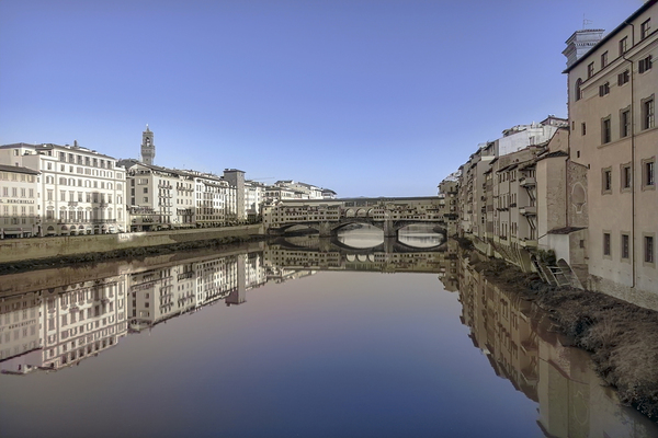 Ponte Vecchio bridge in Florence Italy beautifully reflected in the Arno rivers waters. by IB Photography