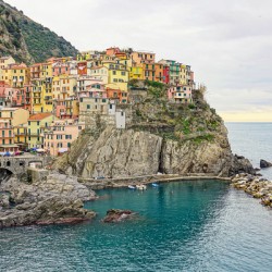 Manarola village in Cinque Terre Italy sitting beautifully on a cliff along the coast.