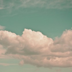 A beautiful scene featuring soft fluffy clouds against a gentle turquoise sky backdrop.