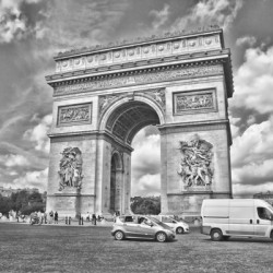 Arc de Triomphe in Paris captured in a dramatic black and white photograph.