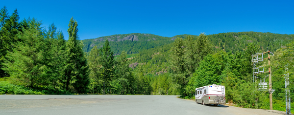 Luxury motorhome on a wide asphalt road in Canadian rocky mountains by ImageNet