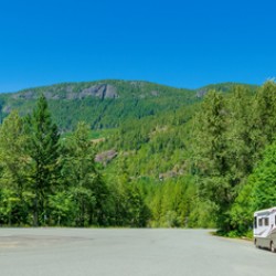 Luxury motorhome on a wide asphalt road in Canadian rocky mountains