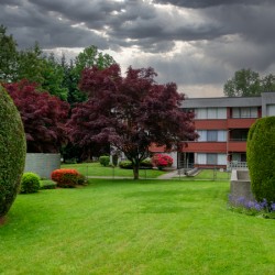 Residential apartment building on stormy sky background