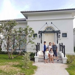 A Family Moment in Front of Their Villa