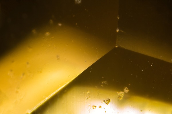 Yellow gem under the microscope Print