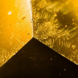 Yellow gem under the microscope