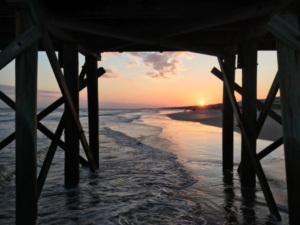 Under the pier at Isle of Palms by Greg Brzozowski