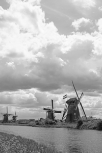 BW The Sun Plays in the Clouds over Kinderdijk Netherlands with the Windmills