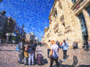  luggage on French street with iconic tall building of train sta