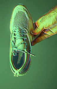 POV male hand holding new running shoes with Nike logotype on the sole