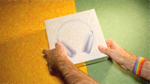 POV male hand holding package of the best over ear headphones