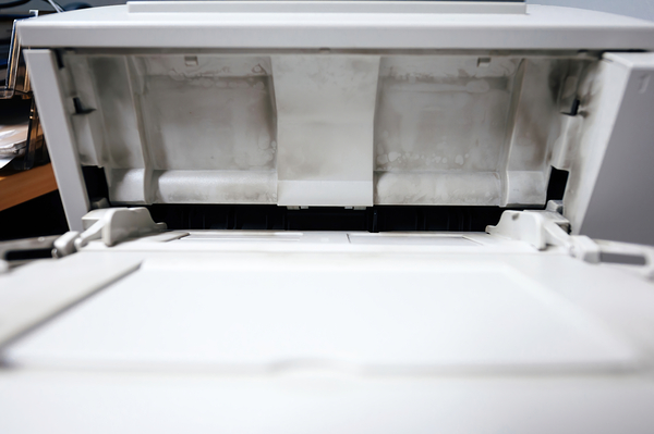 Dirty with printing dust from toner open paper tray on the vintage laser printer Print