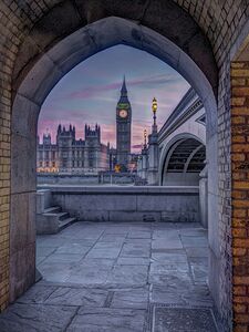 View of Westminster Abby and Big Ben from Thames promenade arch London UK