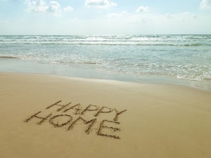 Happy Home written in sand on the beach