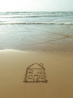 Sweet home drawn on sand at the beach